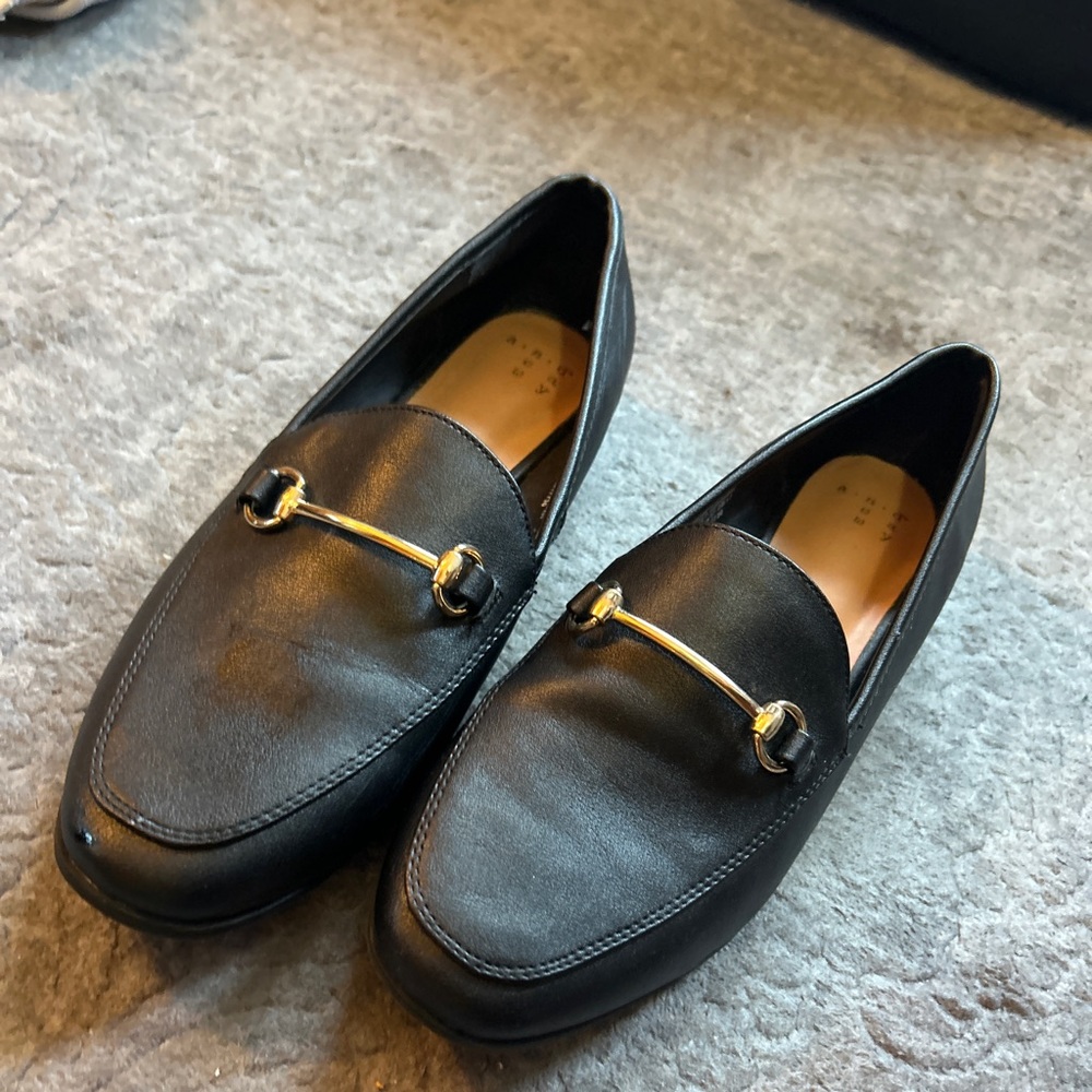black loafers with gold detail
